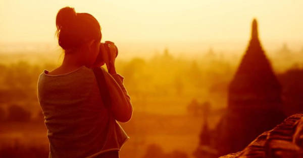 An image showcasing a woman taking a photo of Egypt's beauty