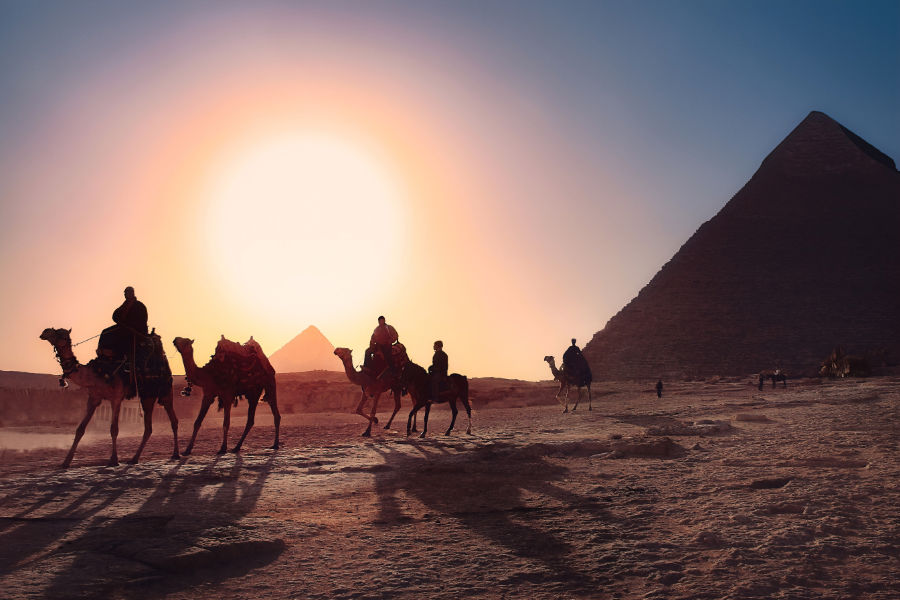 Image showing Giza Pyramids and people riding camels